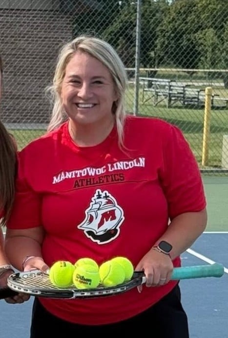 Paige Cotton holding tennis racket and tennis balls