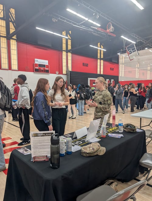 students talking with a recruiter