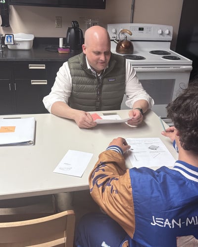 mielke going over a sheet with student