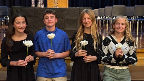 STUDENTS HOLDING ROSES