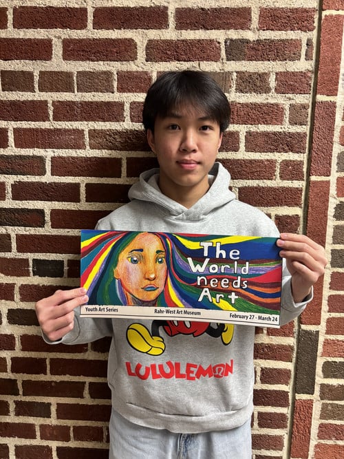 Isiah Moua HOLDS HIS BILLBOARD MOCK UP. 