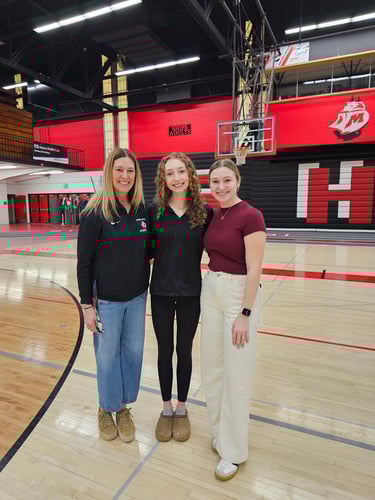 khloe jabert and coaches tatum and jacque bartow posing together at the send off in the gym