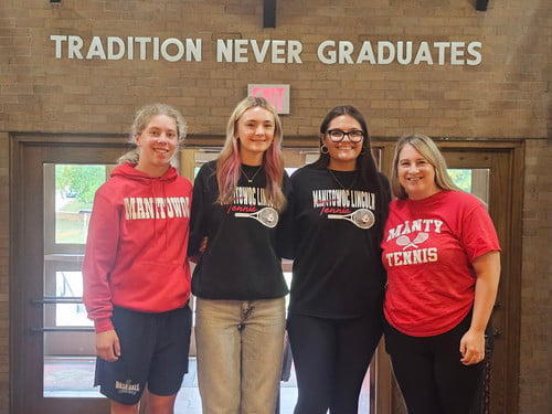 Ava Wetenkamp, Elighana Camacho and Julia Jagemann pose with Coach Cotton
