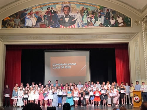 Group photo on stage of senior scholarship recipients