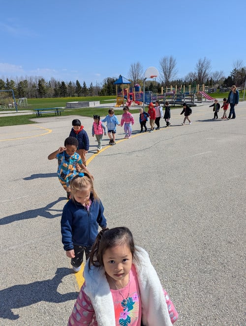 Riverview students walking in line on asphalt lot