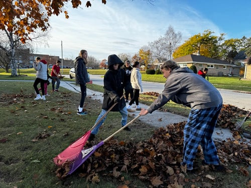 Students rake yards near Wilson